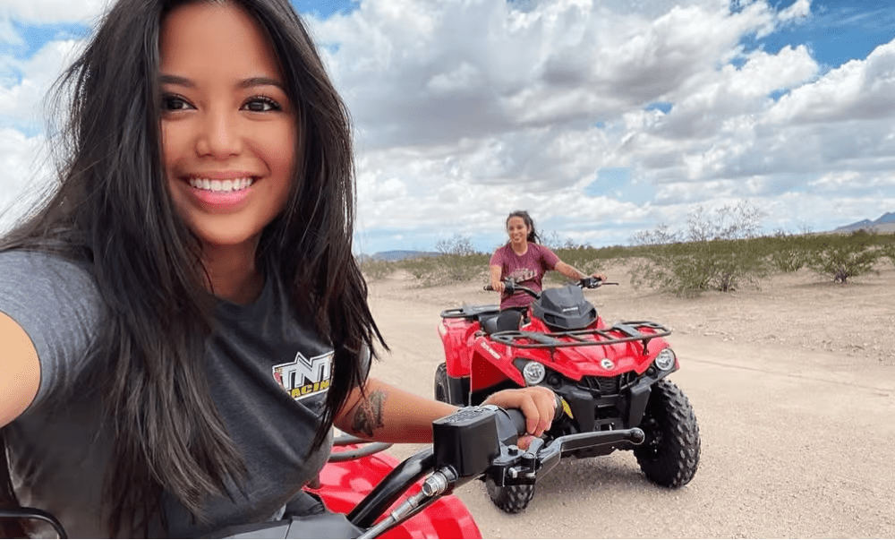 Two women take selfies when they are riding ATV.