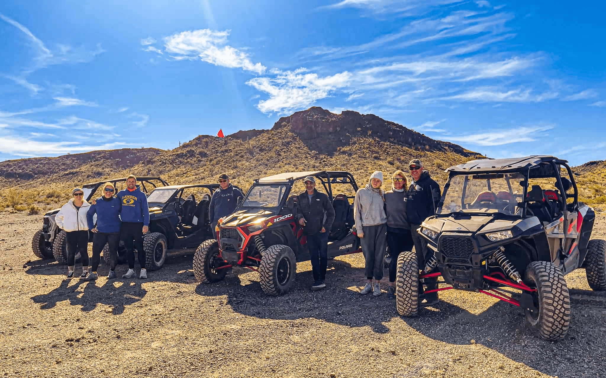 Adventure Club group people posing for a picture in a mountain.