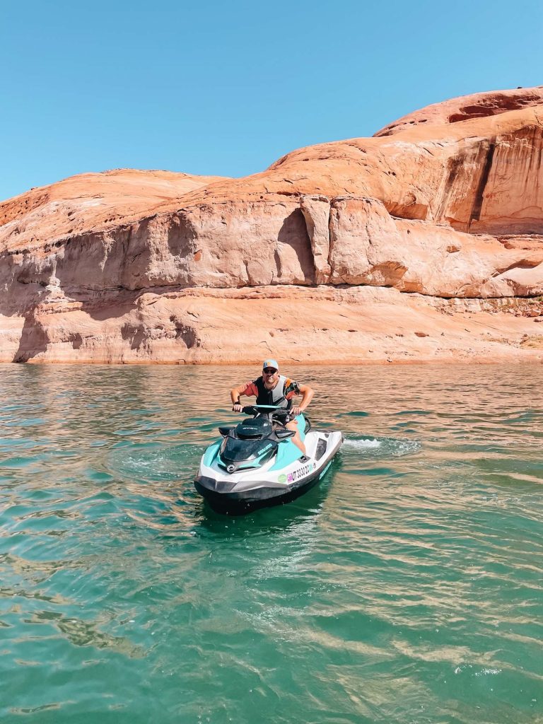 A man is riding a jet ski on the water.