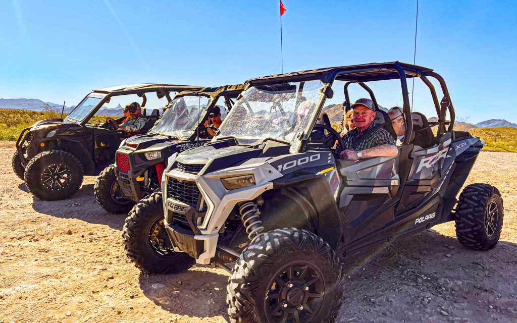 Adventure club riding three ATV .