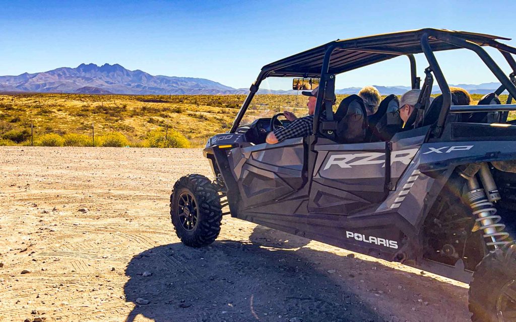 A group of people adventure in an ATV.