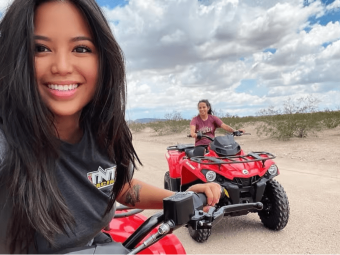 Two women take selfies when they are riding ATV.