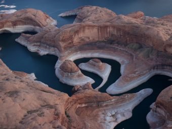 LAKE POWELL, UTAH - JUNE 24: The tall bleached "bathtub ring" is visible on the rocky banks of Lake Powell at Reflection Canyon on June 24, 2021 in Lake Powell, Utah. As severe drought grips parts of the Western United States, a below average flow of water is expected to flow through the Colorado River Basin into two of its biggest reservoirs, Lake Powell and Lake Mead. Lake Powell is currently at 34.56 percent of capacity, a historic low. The lake stands at 138.91 feet below full pool and has dropped 44 feet in the past year. The Colorado River Basin supplies water to 40 million people in seven western states. (Photo by Justin Sullivan/Getty Images)